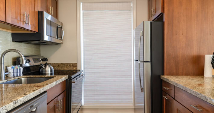 Kitchen with microwave, stove, refrigerator
