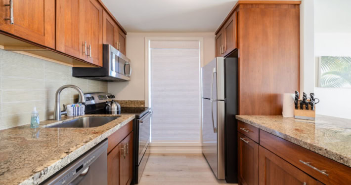 Full kitchen with refrigerator, stove and microwave