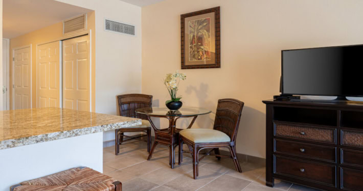Dining area next to the kitchen, television on dresser