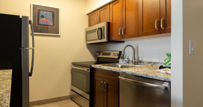 full kitchen with stove, microwave, dish washer and refrigerator