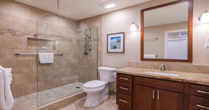 updated bathroom with walk-in shower and large mirror and light fixtures